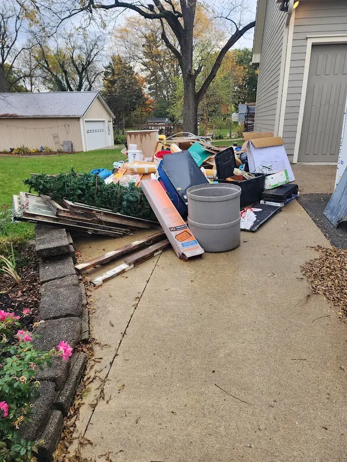 Dumpster being loaded with debris for 12 Yard Dumpster Rental in Reading